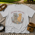 Sport Grey T-shirt mockup featuring golden-coated dog beside floral cowboy boots and flowers beneath Stay Wild Sweet Soul.