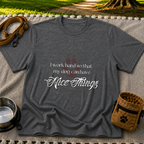 a paw and a “work hard so my dog can have nice things” message. On a Dark Heather Grey T-shirt.