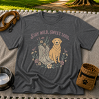 Dark Heather Grey T-shirt mockup featuring golden-coated dog beside floral cowboy boots and flowers beneath Stay Wild Sweet Soul.