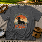 Dark Heather Grey T-shirt mockup featuring dachshund portrait in a striped sunset badge with Dachshund Parent lettering.