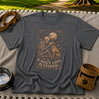 Dark Heather Grey T-shirt mockup featuring a seated dog and skeleton beneath moons and planets with A Dog’s Love Is Eternal.
