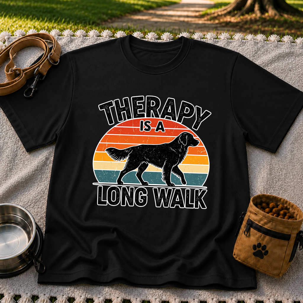 Black T-shirt mockup featuring dog silhouette walking across a striped sunset beneath Therapy Is a Long Walk.