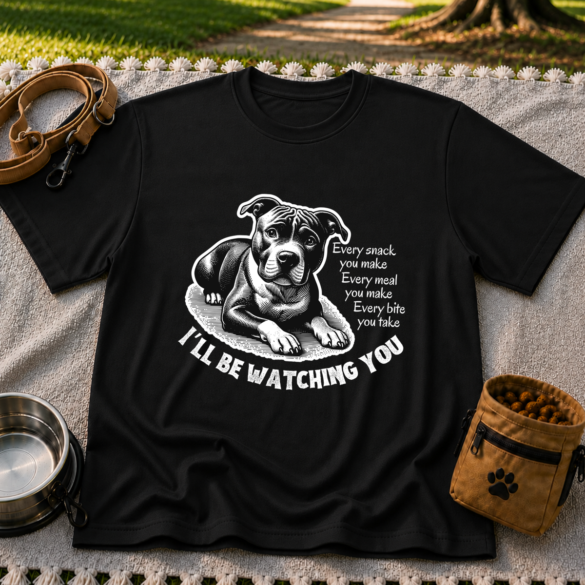 a watchful dog paired with a line about keeping an eye on you. On a Black T-shirt.