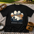 Black T-shirt mockup featuring hiker and dog following a mountain trail framed inside a paw print.