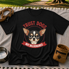 Black T-shirt mockup featuring Chihuahua portrait above a red Trust Dogs Not Billionaires banner.