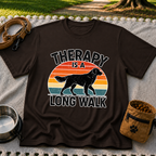 Dark Chocolate T-shirt mockup featuring dog silhouette walking across a striped sunset beneath Therapy Is a Long Walk.