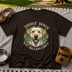 a Labrador portrait framed by “Trust Dogs Not Billionaires”. On a Dark Chocolate T-shirt.