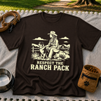 Dark Chocolate T-shirt mockup featuring western ranch scene with a rider, dog, open landscape, and Respect the Ranch Pack lettering.