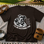 a watchful dog paired with a line about keeping an eye on you. On a Dark Chocolate T-shirt.