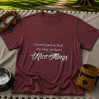 a paw and a “work hard so my dog can have nice things” message. On a Maroon T-shirt.