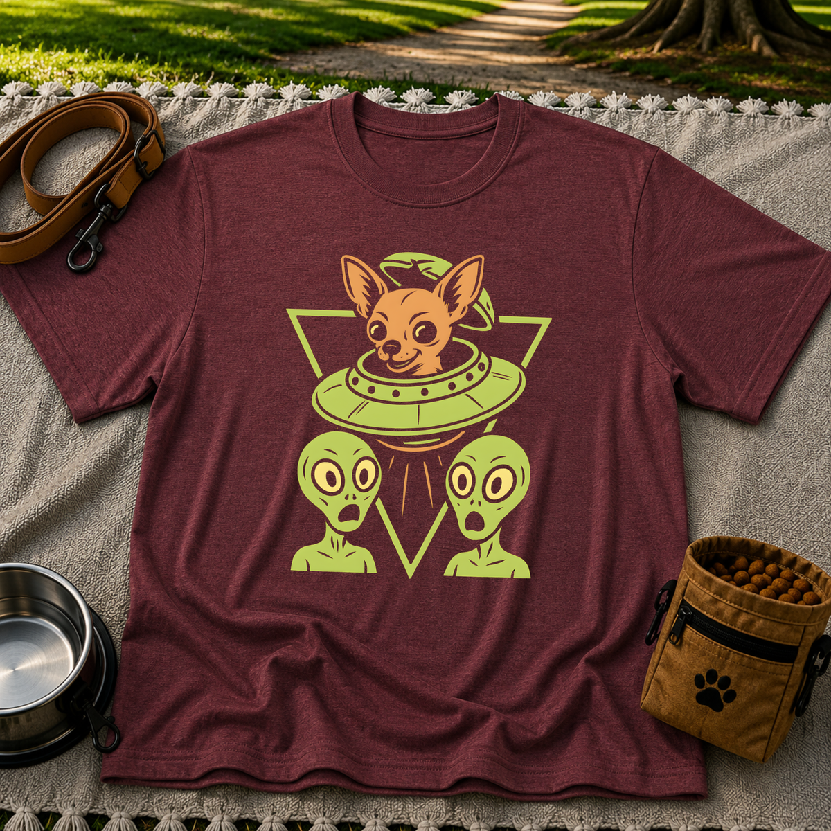 Maroon T-shirt mockup featuring oversized-eared Chihuahua in a flying saucer above two small aliens.