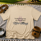 a paw and a “work hard so my dog can have nice things” message. On a Sand T-shirt.