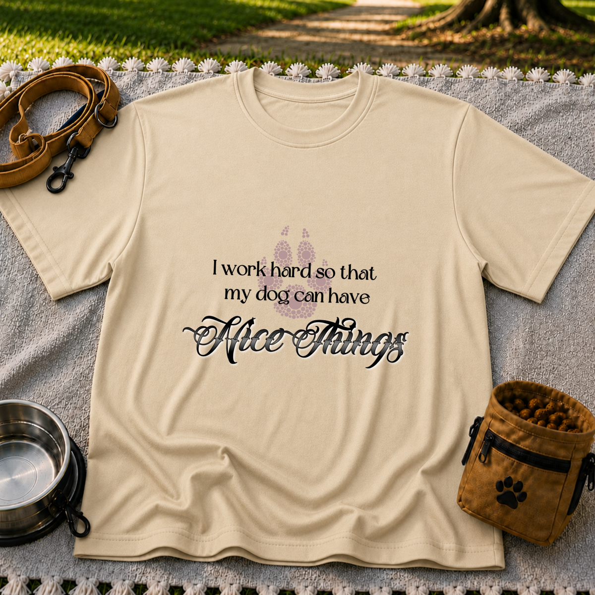 a paw and a “work hard so my dog can have nice things” message. On a Sand T-shirt.
