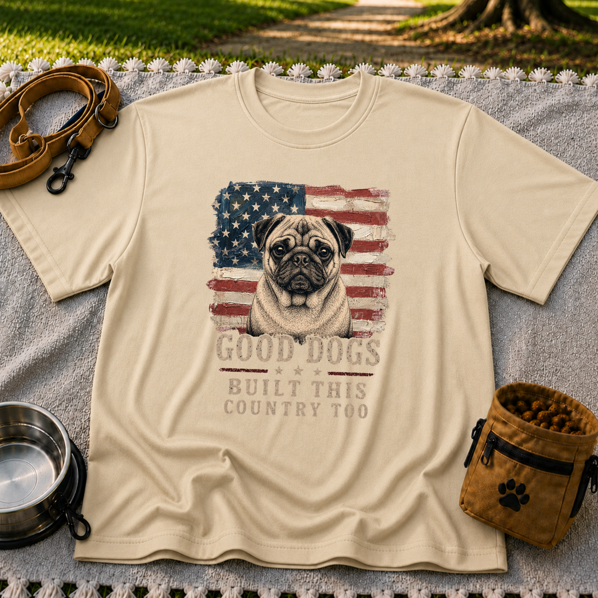 Sand T-shirt mockup featuring pug portrait against a distressed American flag with patriotic lettering.