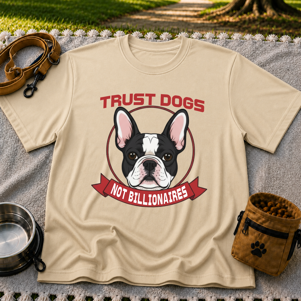 Sand T-shirt mockup featuring French Bulldog portrait in a circular badge above a red Trust Dogs Not Billionaires ribbon.