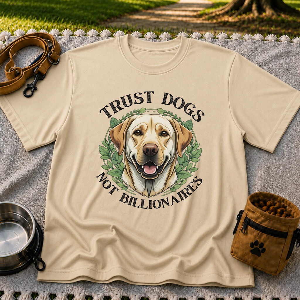 a Labrador portrait framed by “Trust Dogs Not Billionaires”. On a Sand T-shirt.