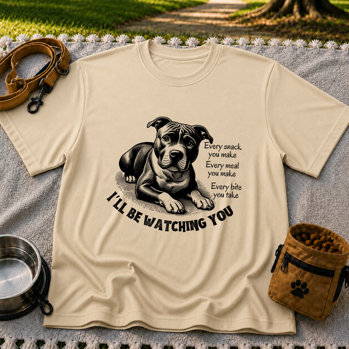 a watchful dog paired with a line about keeping an eye on you. On a Sand T-shirt.