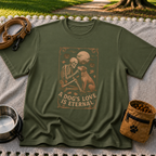 Military Green T-shirt mockup featuring a seated dog and skeleton beneath moons and planets with A Dog’s Love Is Eternal.