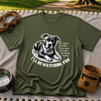 a watchful dog paired with a line about keeping an eye on you. On a Military Green T-shirt.