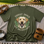 a Labrador portrait framed by “Trust Dogs Not Billionaires”. On a Military Green T-shirt.