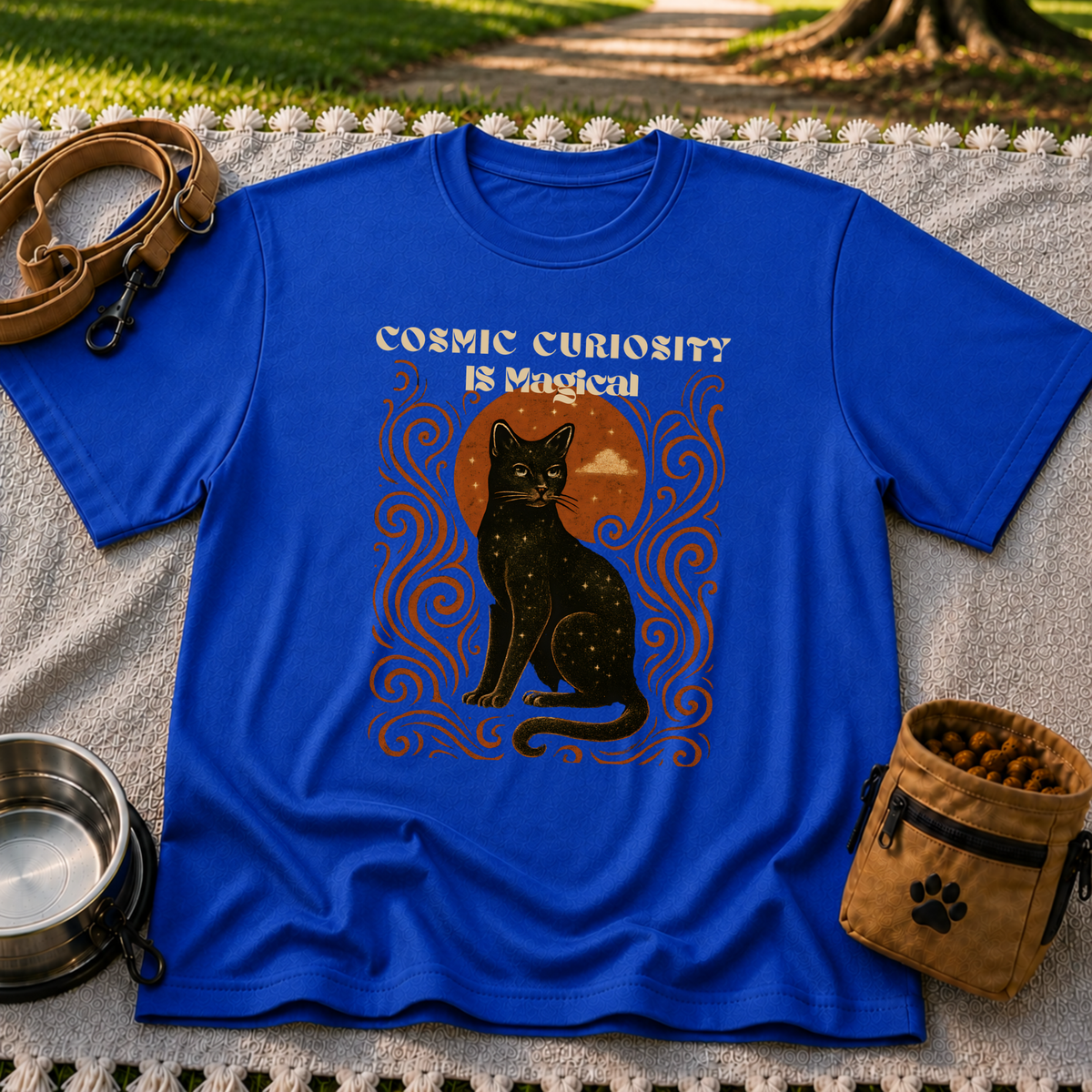 Black cat, moonlike circle and surrounding stars on a Royal T-shirt.