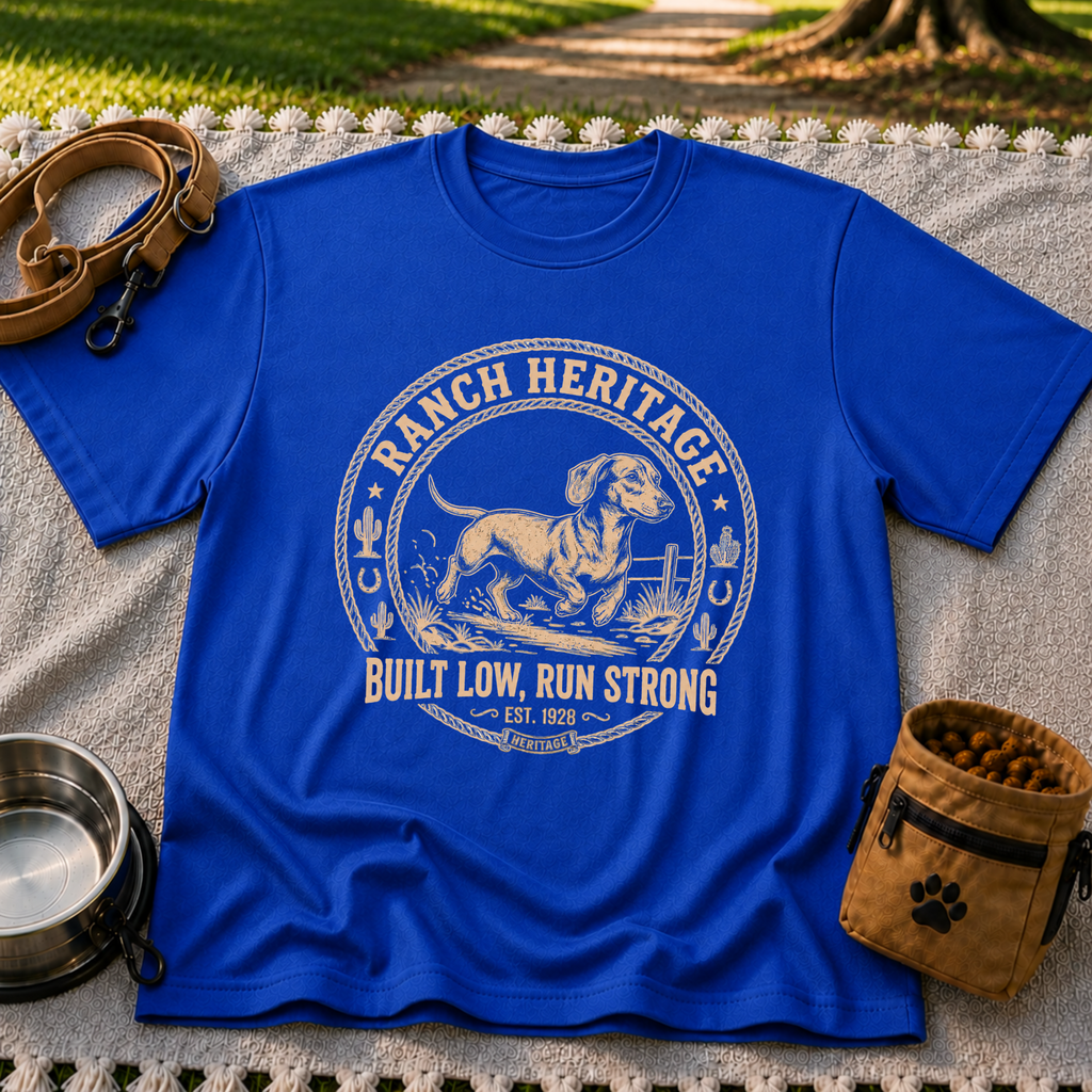 a Dachshund running inside a “Ranch Heritage” western emblem. On a Royal T-shirt.