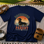 Navy T-shirt mockup featuring dachshund portrait in a striped sunset badge with Dachshund Parent lettering.